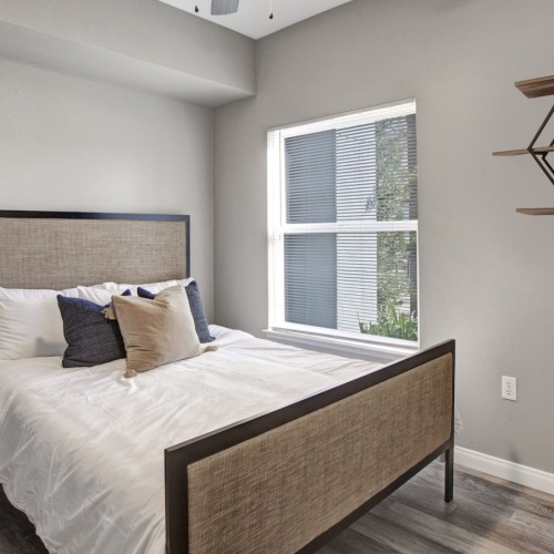 a bedroom with a bed and a window