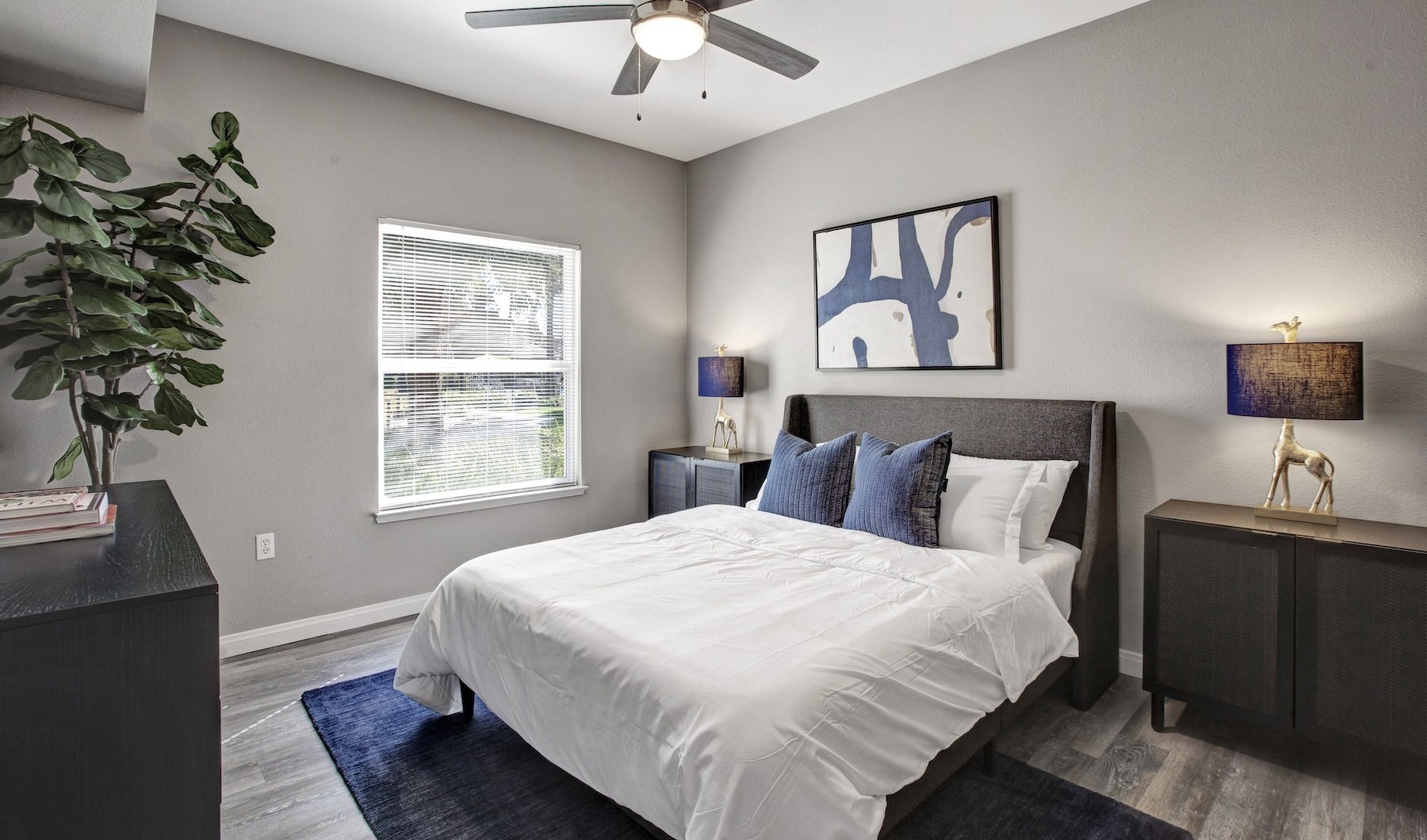 a bedroom with a bed and two nightstands